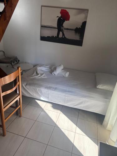 a bed in a room with a red umbrella at Apartments Barbie in Rethymno Town