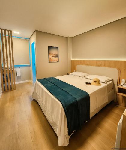 a bedroom with a large bed in a room at Joaquina Beach Hotel in Florianópolis