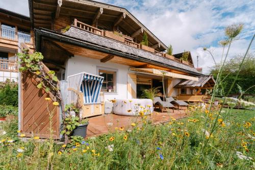 a house with a patio in the yard at TraumChalet mit Sauna in Kirchberg im Skigebiet Kitzbühel in Kirchberg in Tirol