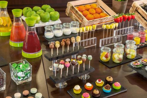 a table topped with different types of desserts and fruits at NH Ingolstadt in Ingolstadt