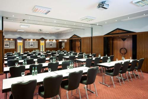 a large room with tables and chairs in it at NH Ingolstadt in Ingolstadt