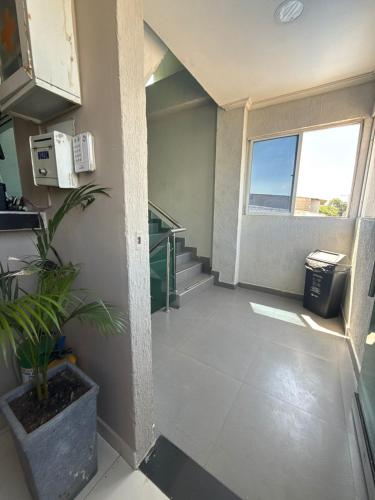 a room with a staircase with a potted plant at hotel gloria del norte sas in Cartagena de Indias