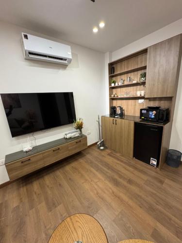 a living room with a large flat screen tv at جناح فندقي بغرفتي نوم 5 نجوم في المهندسين 10a Deluxe Suite in Cairo