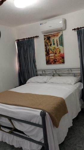 a bedroom with a large bed with aintendent at Recidencial sharael house in San Isidro