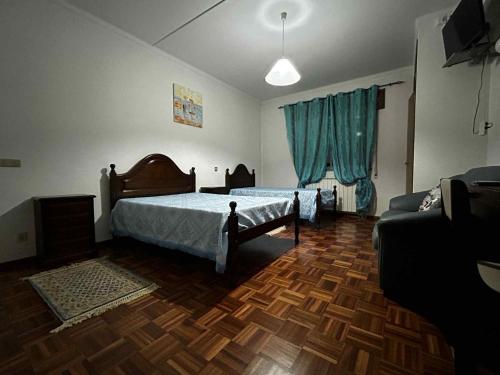 a bedroom with a bed and a couch at Campinho Café Alojamento Local in Fátima
