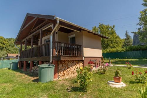 a house with a balcony and a yard at Tornácos Vendégház in Salgótarján