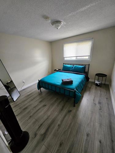 a bedroom with a blue bed in a room at The Onyx Suite In Inglewood Minutes To DT in Calgary