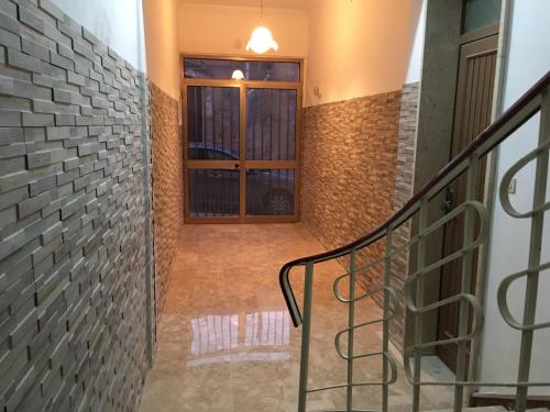 a staircase with a brick wall and a window at La CASA DEL SOLE in Paceco
