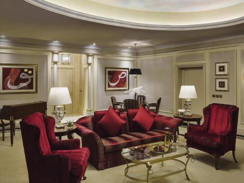 a living room with a couch and two chairs at Mövenpick Hotel Al Khobar in Al Khobar