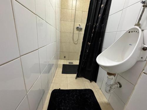 a bathroom with a sink and a toilet and a shower at Residencial Don Santiago in Talca