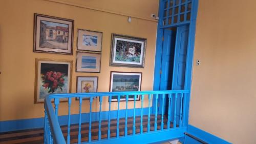a room with a blue crib and pictures on the wall at General Hostel Belém in Belém