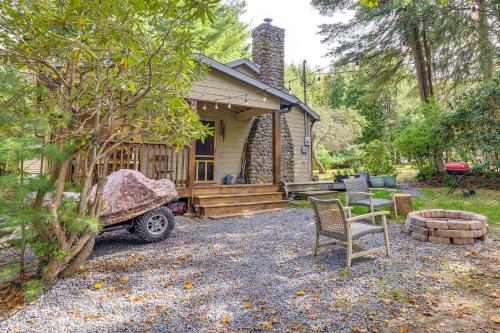 a small cabin with a table and chairs in front of it at Ski, Swim, Relax Old-Fashioned Poconos Getaway in Pocono Pines