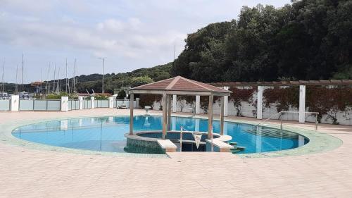 a swimming pool with a gazebo in the middle at Floating House - LUXURY Floating Sea OASIS Pula in Pula