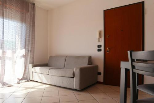 a living room with a couch and a window at Mira Venice Apartment in Mira