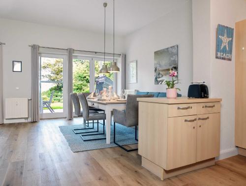 a kitchen and dining room with a table and chairs at Ostsee Residenz Meeresblick Dünenblick in Insel Poel