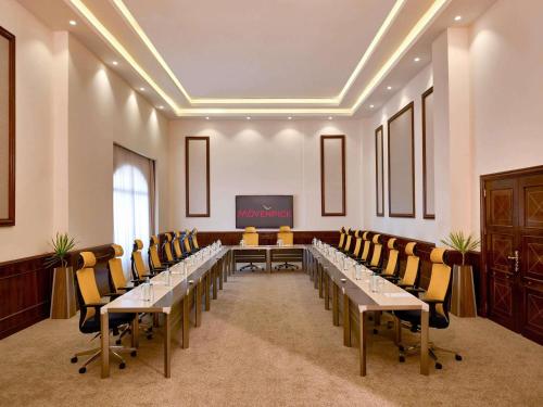 a conference room with a long table and chairs at Mövenpick Hotel Cairo - Media City in 6th Of October