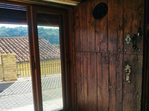 a room with a wooden door and a window at LA DULA, Casa Boutique en el casco antiguo y junto a la montaña in Villafranca del Cid
