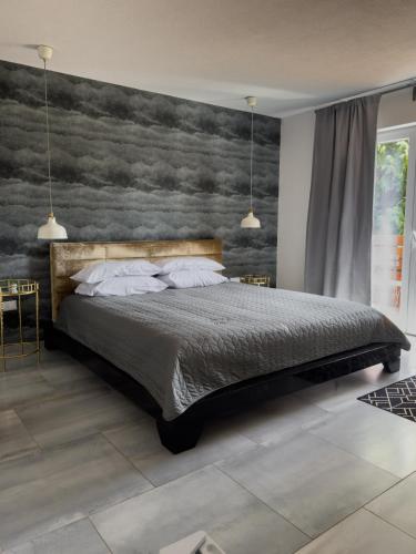 a bedroom with a bed with a painting on the wall at O'Toole's, Plitvice in Korenica