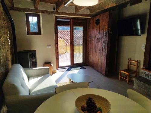 a living room with a couch and a table at LA DULA, Casa Boutique en el casco antiguo y junto a la montaña in Villafranca del Cid