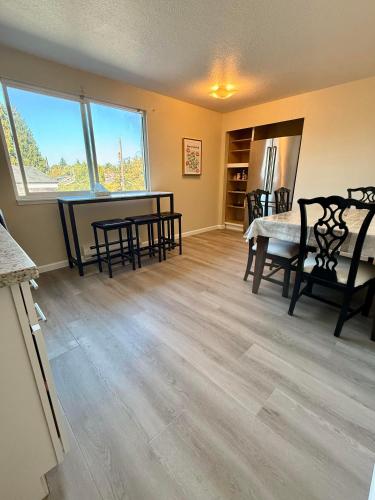 an empty living room with a table and chairs at Private Room by UW in Seattle