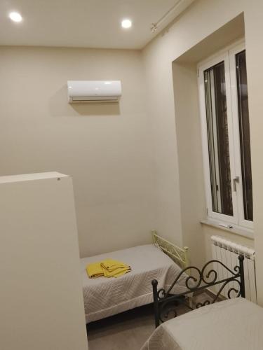 a small room with a small bed and a window at GIOIA Holiday Home in Torre del Greco