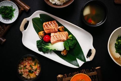 a plate of food with meat and vegetables on a table at Regent Chongqing - Complimentary 1st round mini bar daily in Chongqing