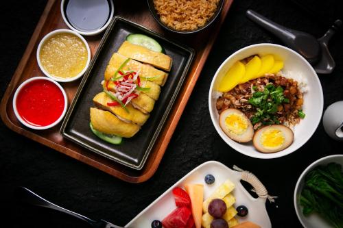 a table with plates of food and bowls of food at Regent Chongqing - Complimentary 1st round mini bar daily in Chongqing