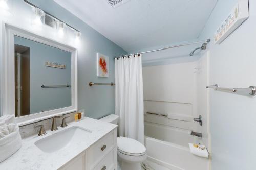 a bathroom with a sink and a toilet and a mirror at Emerald Towers West 5001 in Fort Walton Beach
