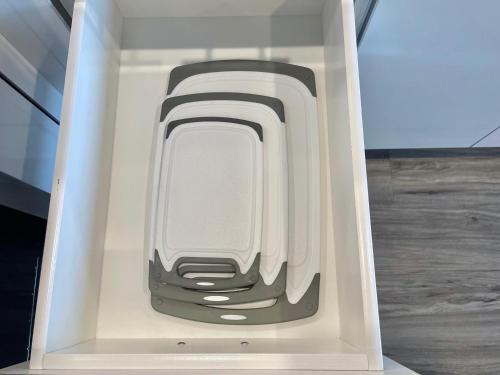 a white drawer with a cell phone in it at Elevator-Downtown View-Garage-King Bed-Laundry in Walnut Creek