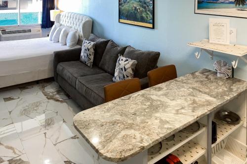 a living room with a couch and a table at Fontainebleau 305 in Panama City Beach