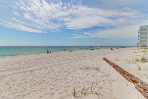 a sandy beach with people in the water and a building at Fontainebleau 305 in Panama City Beach