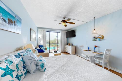 a bedroom with a bed and a dining room at Pirates Bay A215 in Fort Walton Beach