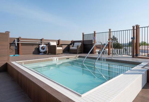 a swimming pool on top of a balcony at Elevator-Downtown View-Garage-King Bed-Laundry in Walnut Creek