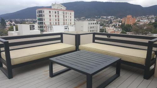 two benches sitting on top of a roof at Apartamento Reyes Catolicos in Salta