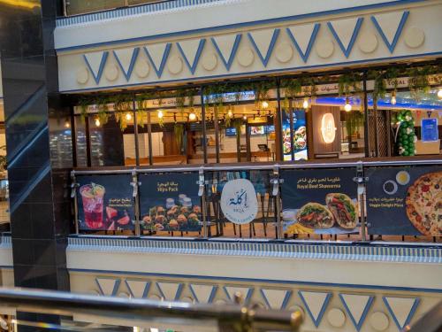 a restaurant with a display of food on a wall at Anwar Al Madinah Mövenpick in Al Madinah