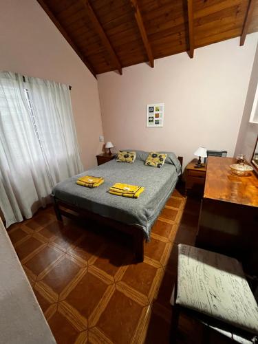 een slaapkamer met een bed in een kamer met houten plafonds bij Lo de Mijo in Dolores