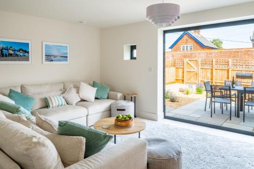 a living room with a couch and a table at Neathercoat in Wells next the Sea