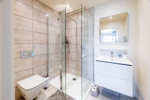 a bathroom with a shower and a toilet and a sink at Neathercoat in Wells next the Sea