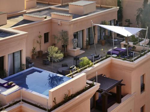 an aerial view of a building with a swimming pool at Mövenpick Hotel Mansour Eddahbi Marrakech in Marrakech