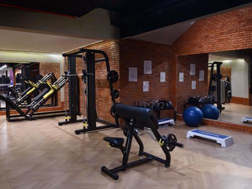 a gym with a lot of equipment in a room at Mövenpick Hotel Mansour Eddahbi Marrakech in Marrakech