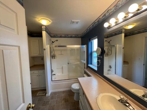 a bathroom with a sink and a shower and a toilet at 3-bedroom house Rockaway Beach in Rockaway Beach