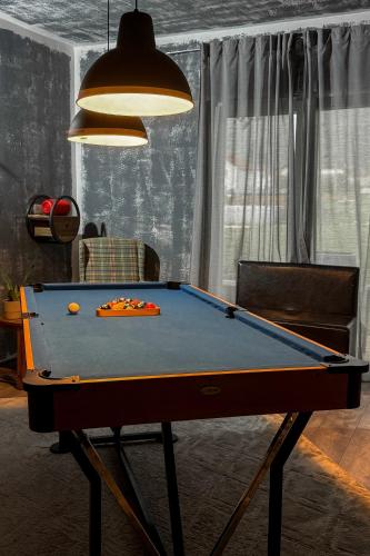 a pool table in a living room with a ping pong ball at O'Toole's, Plitvice in Korenica
