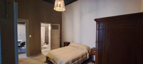 a bedroom with a bed and a room with a table at La Casona in Balcarce