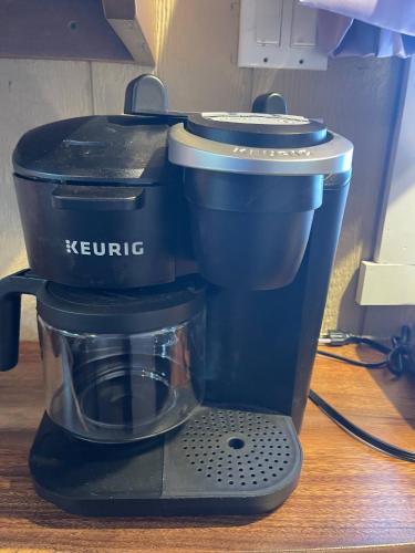 a coffee maker sitting on top of a table at Tiny Tiny Bunkhouse in Cane Beds
