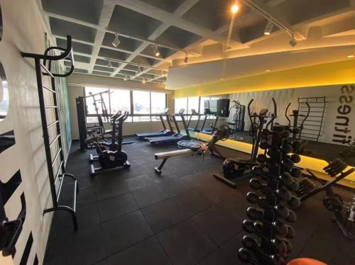 a gym with several treadmills and cardio machines at Smart Stay Experience in Maceió