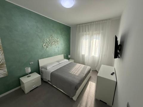 En eller flere senge i et værelse på Appartamenti Rugacesio 24 - Appartamento A