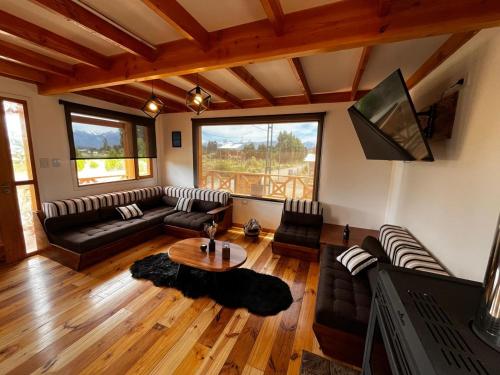 a living room with a couch and a table at Cabañas Los Manzanos in Cholila