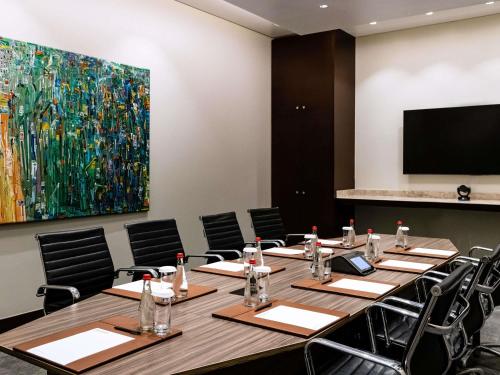 a conference room with a large painting on the wall at Mövenpick Ambassador Hotel Accra in Accra
