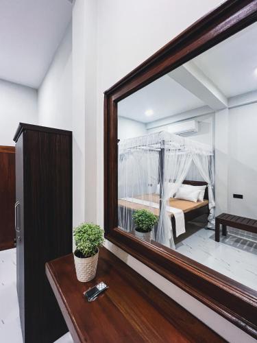 a mirror in a room with a bed in it at Finest Retreat Tangalle - Cozy Villa & Pool, Beach Nearby in Tangalle