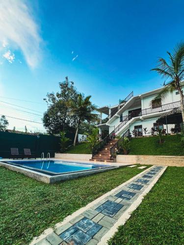 a swimming pool in front of a house at Finest Retreat Tangalle - Cozy Villa & Pool, Beach Nearby in Tangalle